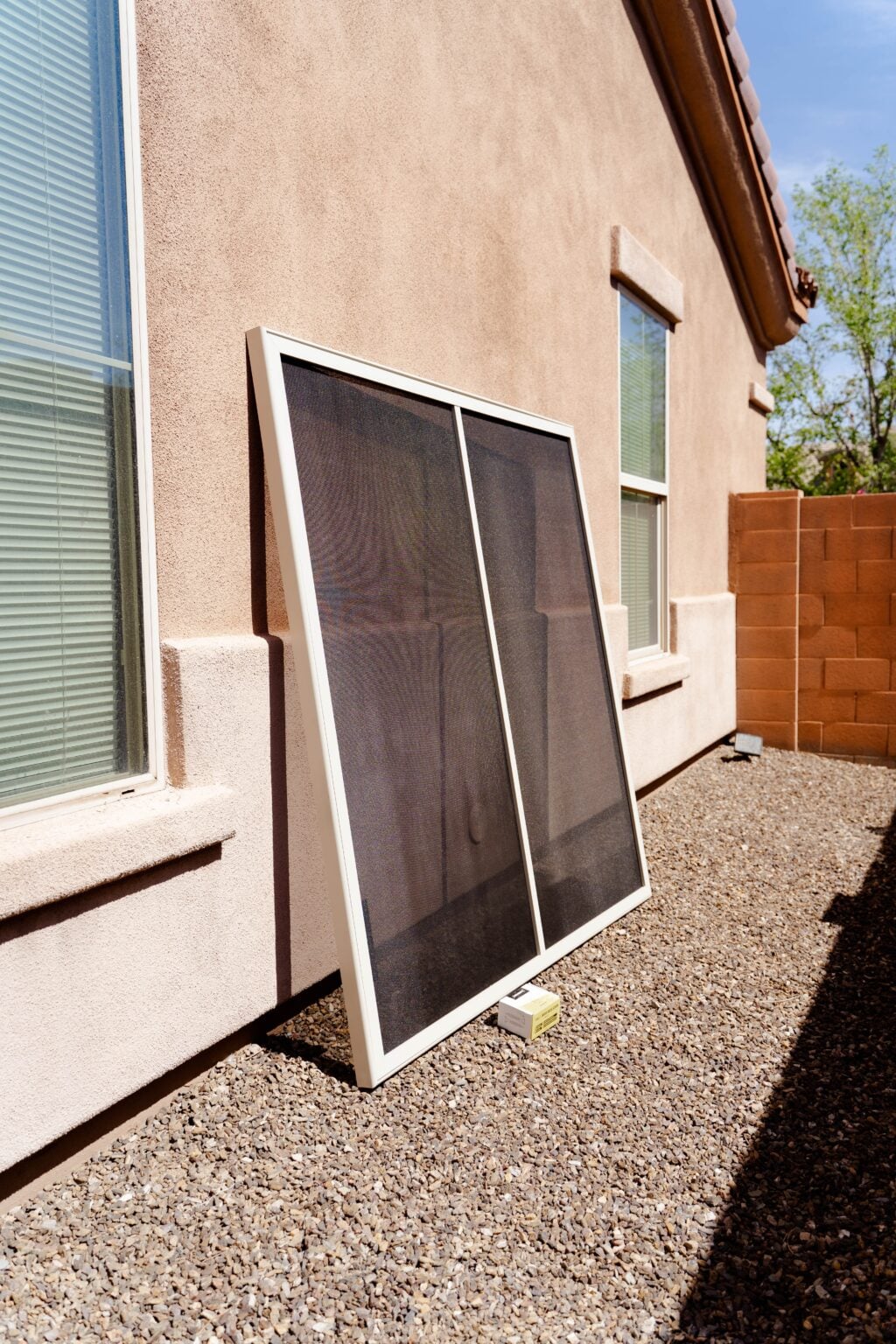 Finished stainless steel window security screen panel waiting to be installed on a Phoenix home